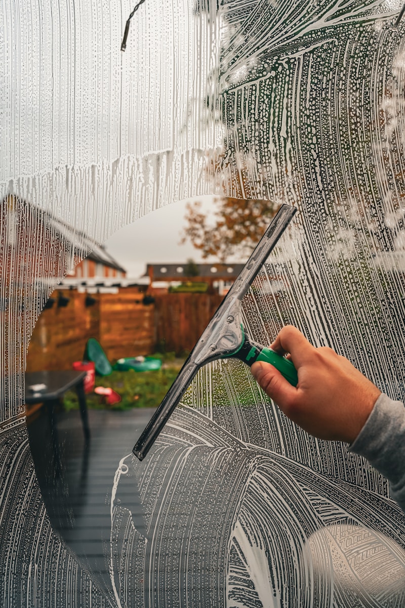 A person is drawing a picture on a window