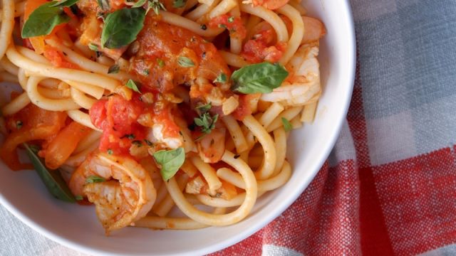 a bowl of pasta with shrimp and tomato sauce